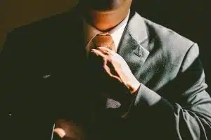 businessman adjusting his necktie
