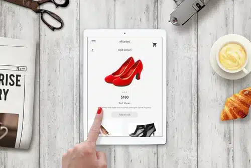 Woman online shopping red shoes with tablet